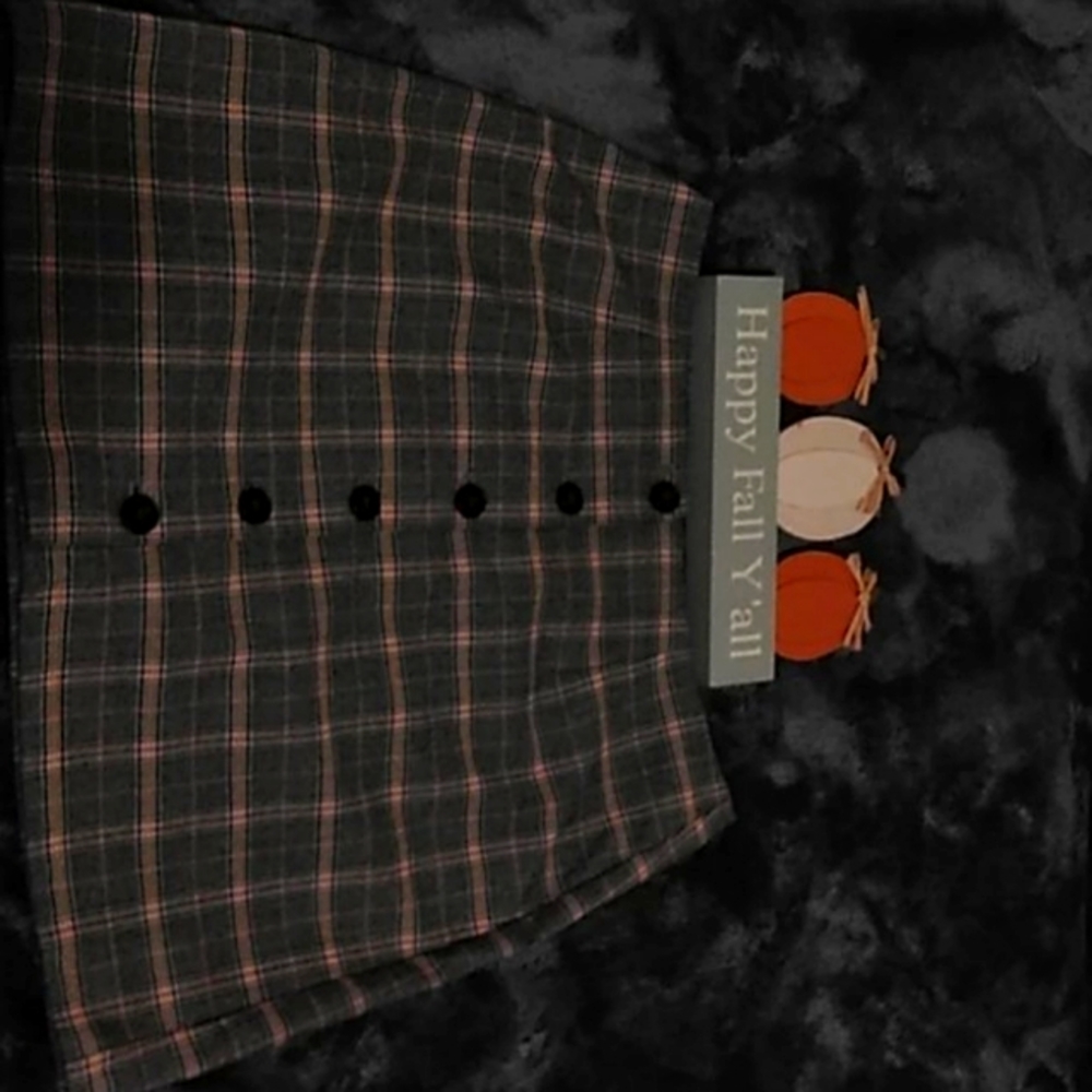 A black and light yellow plaid skirt